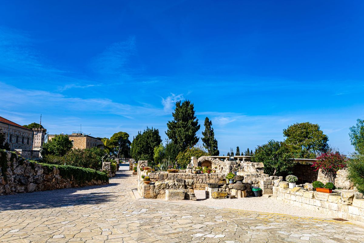 Large natural stone paving leading to a stone garden feature