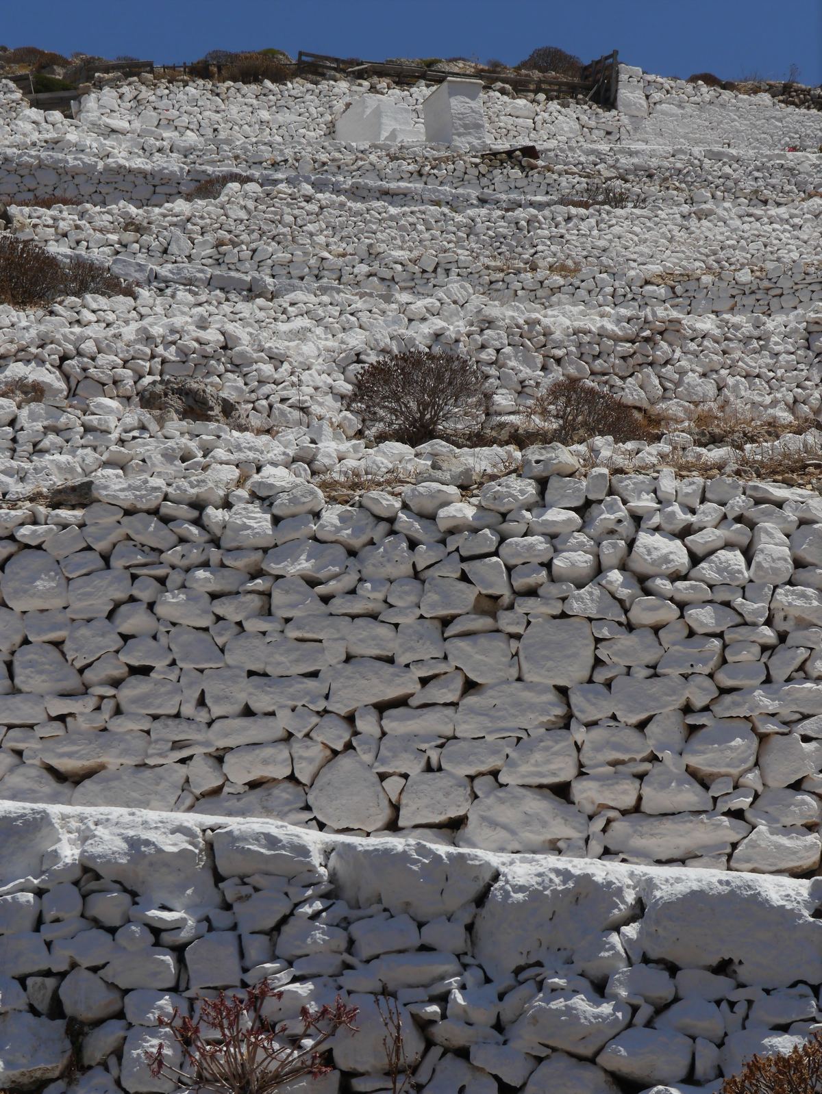 Terraced dry-laid stone retaining walls on a hillside